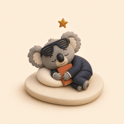 Koda asleep on a small cushion, hugging a book